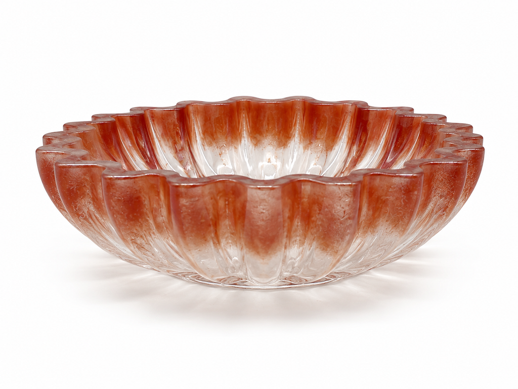 Decorative glass bowl with ribbed design on a white background