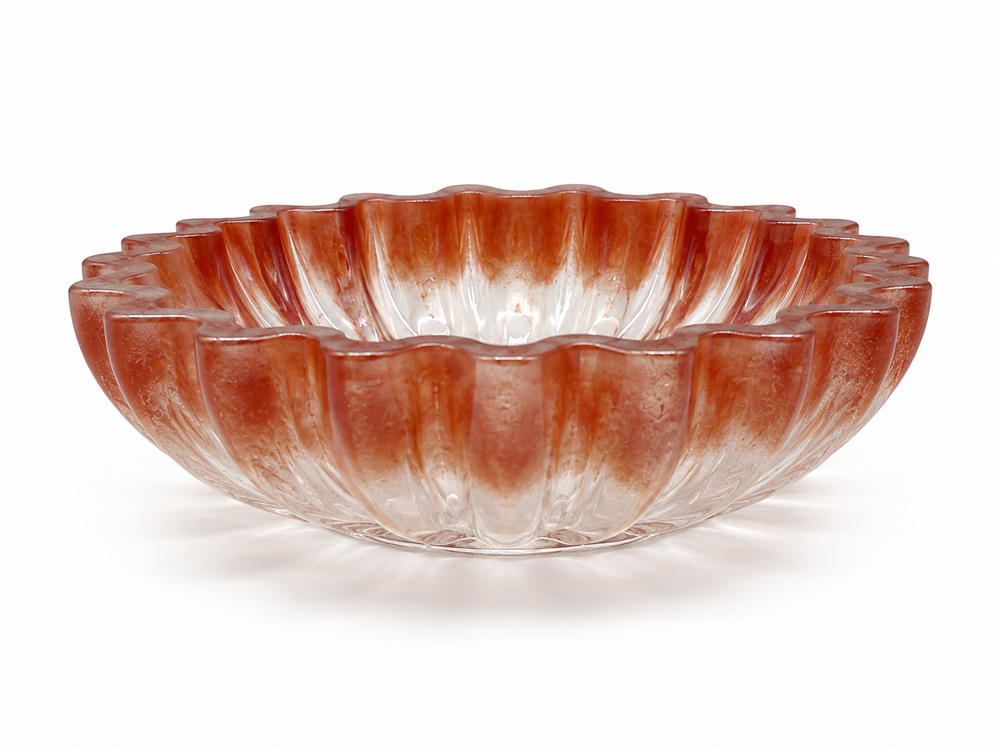 Decorative glass bowl with ribbed design on a white background
